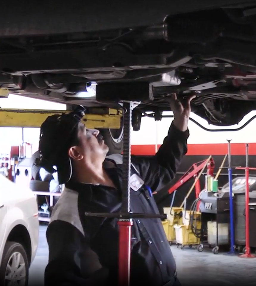 Airpark Auto Clinic technician performing undercar inspection, ensuring reliable and professional auto repair services.