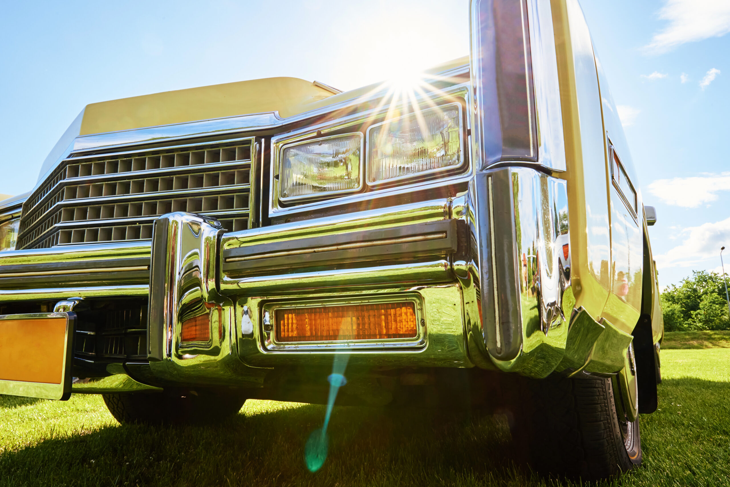 Front view of a vehicle parked in direct sunlight, illustrating how prolonged Arizona heat and UV exposure can damage a car's paint, battery, tires, and interior.
